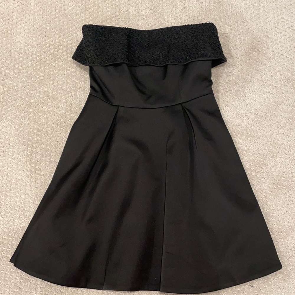 This pretty little black mini dress was worn once.